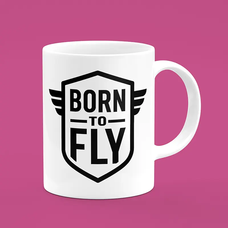 ماگ سفید با طرح بال‌دار و نوشته BORN TO FLY